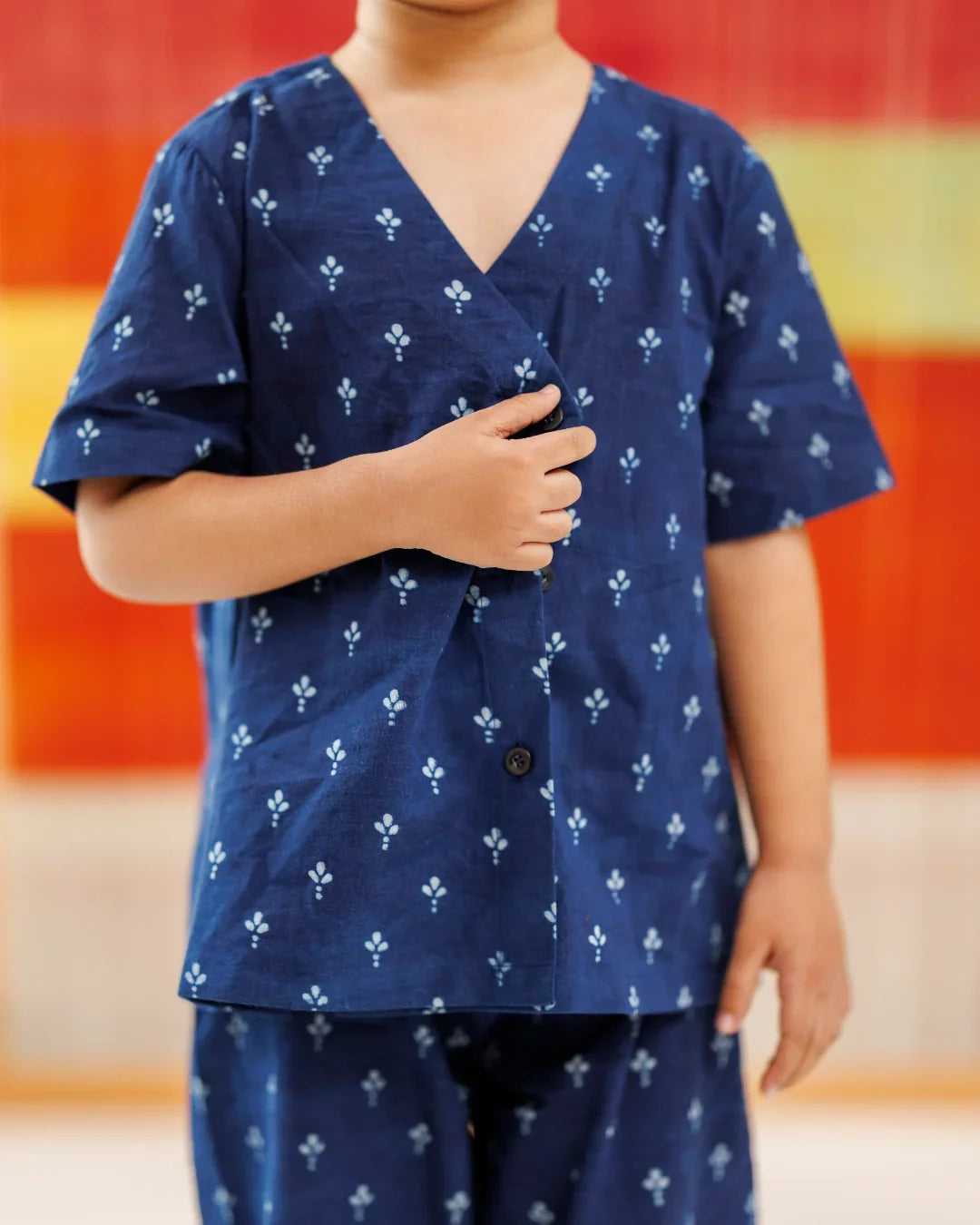 Child wearing blue organic cotton kurta with white block print and matching pants