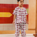 Toddler wearing organic cotton elephant print pajama set, standing indoors