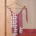 Organic cotton kids romper, half mauve, half white with pink elephant print, on hanger