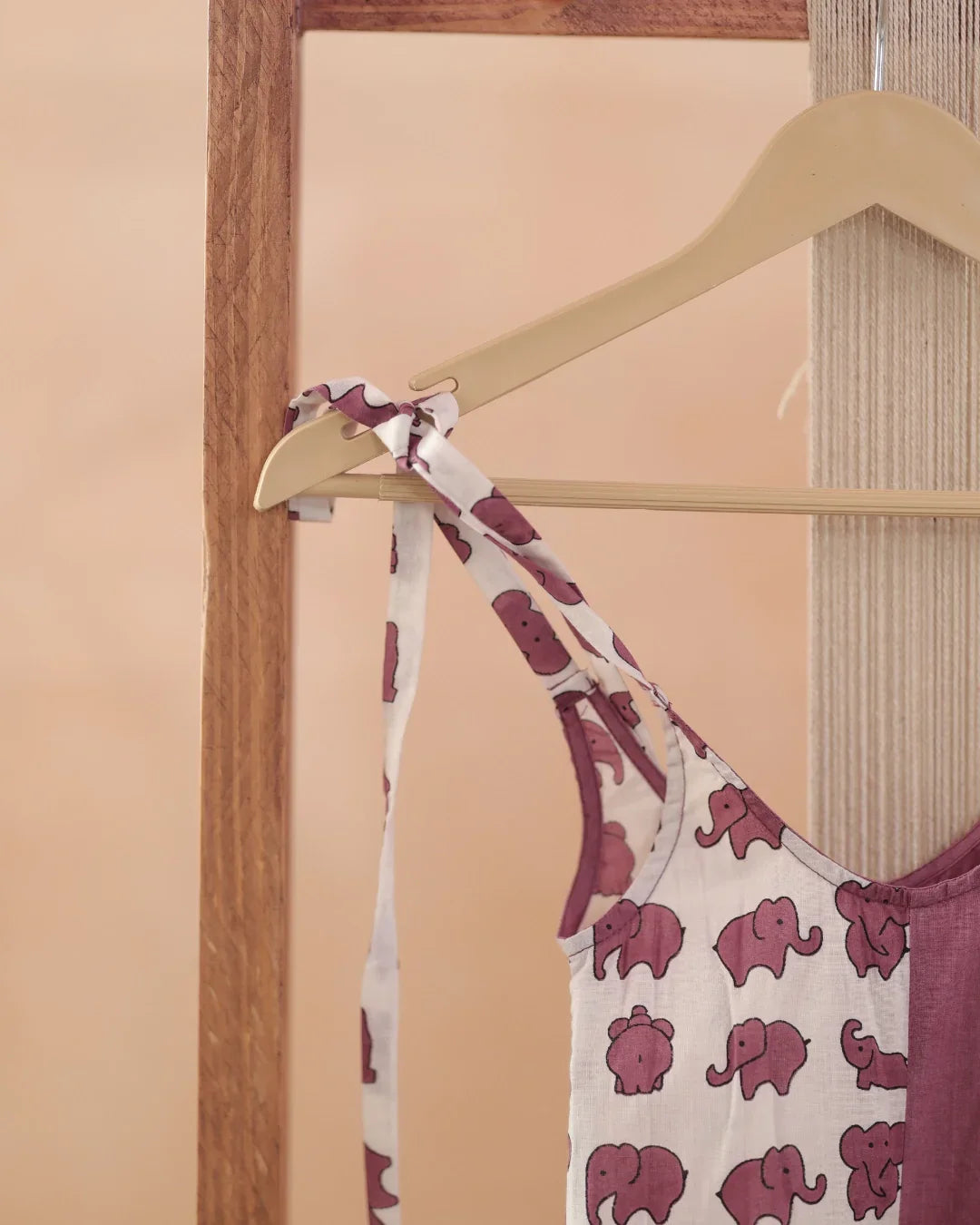 Organic cotton kids dress with purple elephant block print on hanger